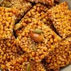 Golden sesame seeds mixed with crunchy snacks for nutrition.