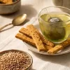 Raw organic whole wheat grains and milled flour used to bake nutritious tea snacks.