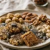 Healthy snacking habits - fibre-rich millet snacks and nuts arranged on a plate