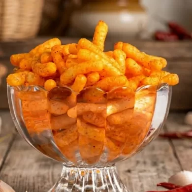 Pack of Farmerette Chilly Garlic Sticks showing a puffed and baked, roasted crunchy snack with less oil and less salt.