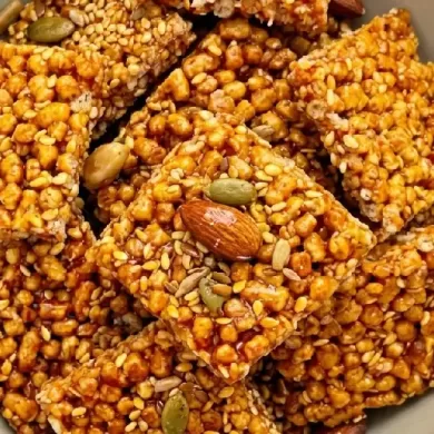 Golden sesame seeds mixed with crunchy snacks for nutrition.